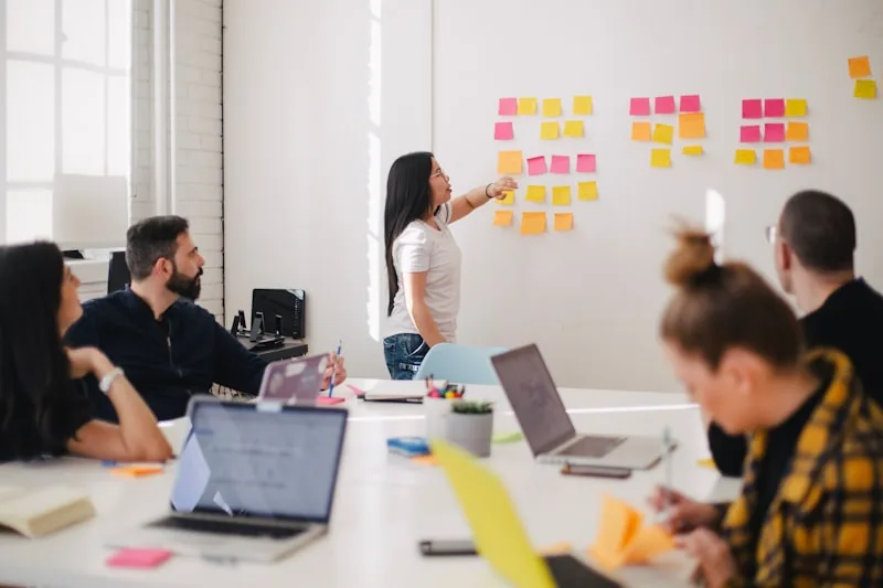 Consultoría empresarial: equipo en una sesión de estrategia con tablero
